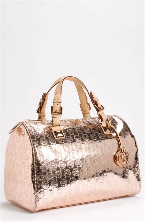 michael kors gold overnight bag|Michael Kors large suitcase.